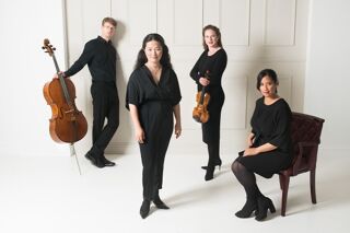 The Villiers Quartet in black clothes stood against cream background