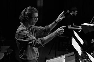 RBC Repertory Big Band director Ed Puddick conducting in black and white