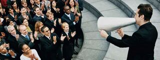7 Event Management Reasons 1200x450 - Man speaking with a loudspeaker to a crowd of people