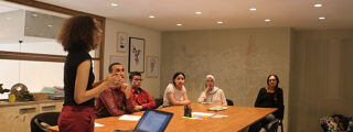 Practitioners listening to a presentation