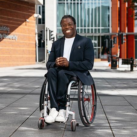 Photo of Ade Adepitan outside the City Centre campus