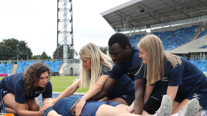 Students on Alexander Stadium running track