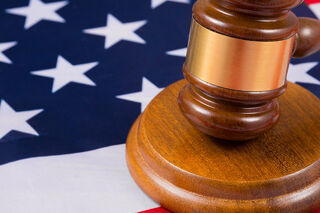 The US flag with a gavel placed over the top