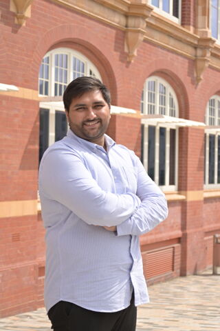 Unigenius owner Amir standing outside of a building