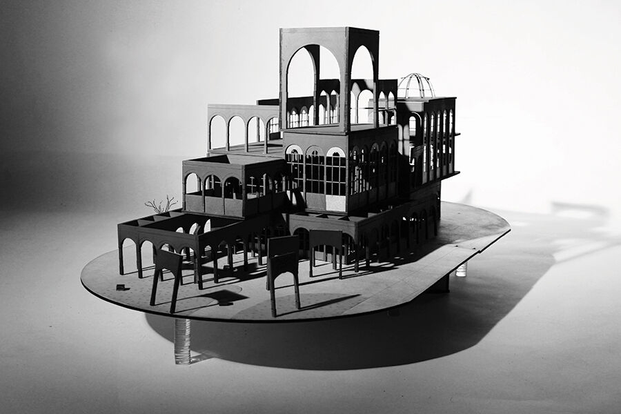 Black and white photo of a multi-level architectural model with arches and a dome, on a turntable-like base