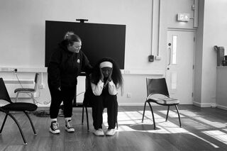 Black and white photo of two female RBC actors in a scene