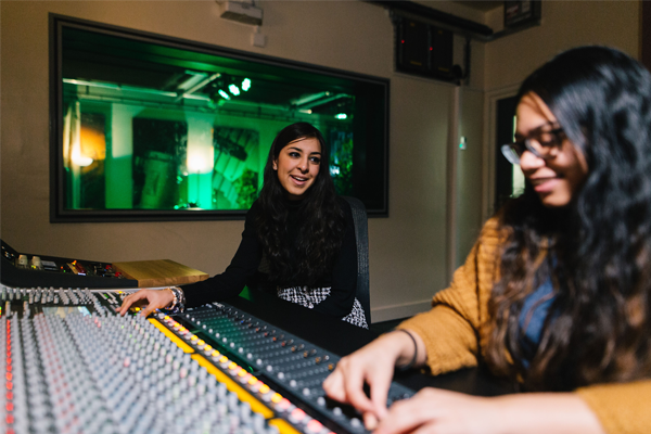 A music production or editing room with sound booth and computer