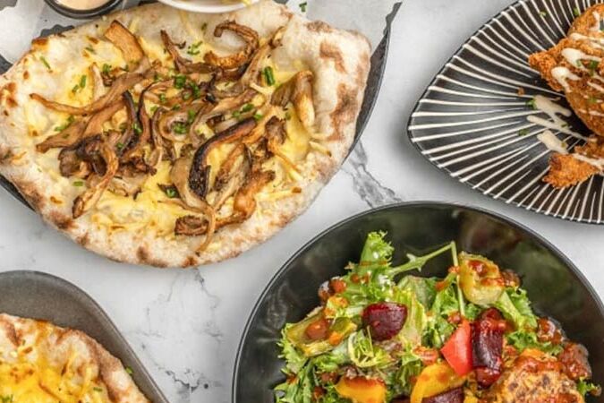 A selection of plates of vegan food, takeaway style