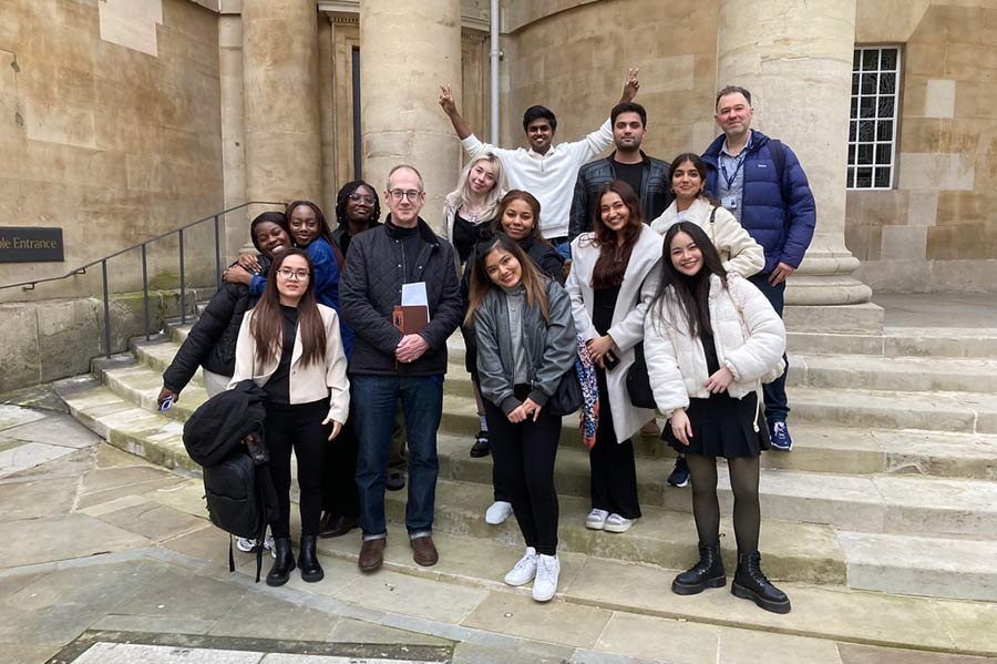 Students and lecturer stood on steps outside BBC
