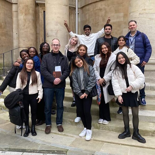 Students and lecturer stood on steps outside BBC