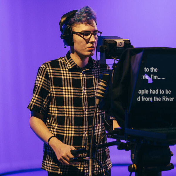 Student operating camera in Studio A