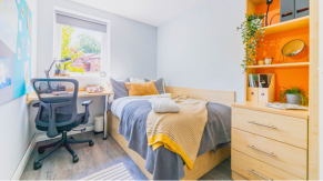 A desk, bed and storage in a bedroom