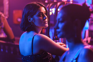 Still from the film 'Before I do'. A young south Asian woman looking at another woman in a bar.