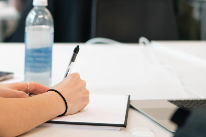 Student writes in a notebook