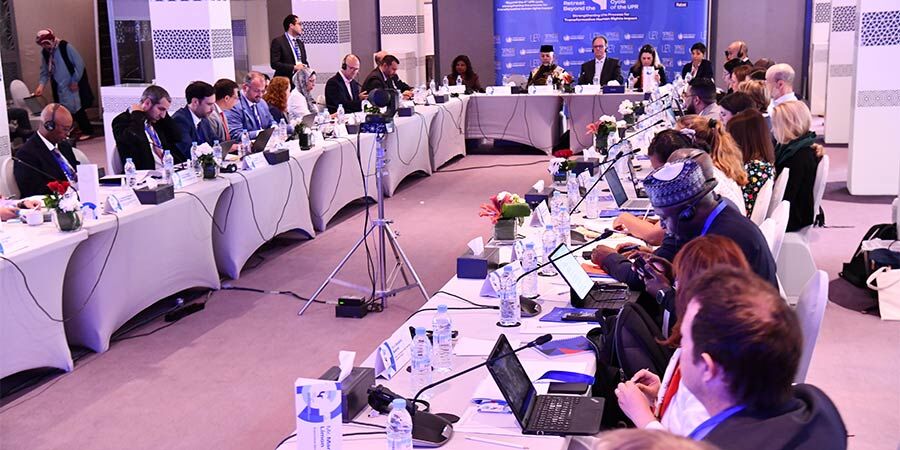 People sat at tables for the 'Beyond the 4th UPR Cycle' UN retreat