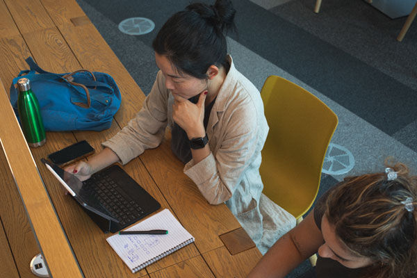 Shot from a above of a student using their laptop