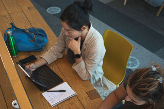 Shot from a above of a student using their laptop