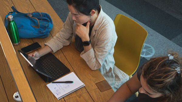 Shot from a above of a student using their laptop