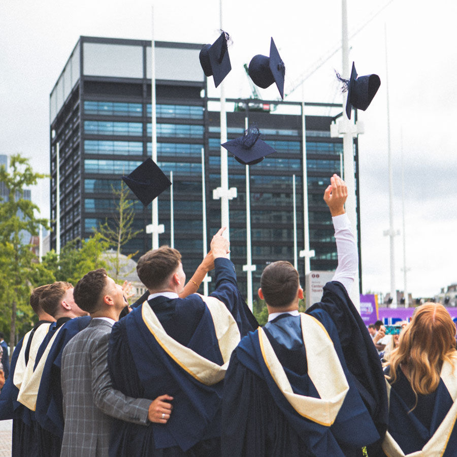Graduates throw their caps in the air
