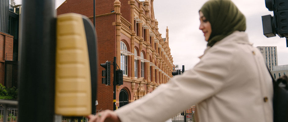 A student presses the button at the traffic lights