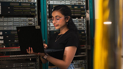 Student on laptop with computer networks