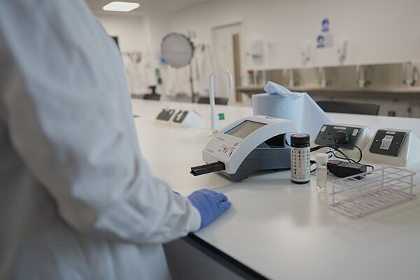 Biomedical Scientist with a urinalysis machine