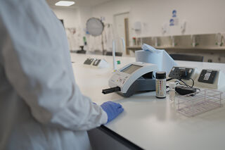 Biomedical Scientist with a urinalysis machine