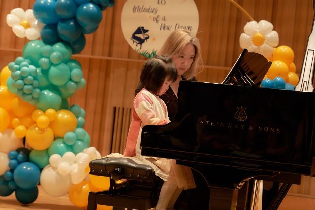 Butterfly sitting on violin bow, violin out of focus in background
