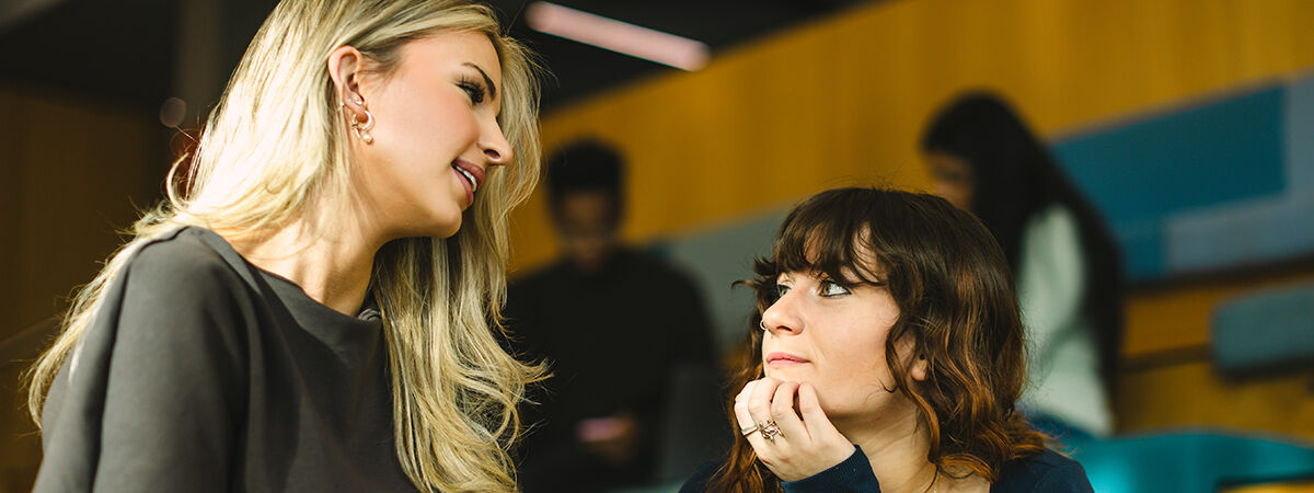 Business Finance MFin Course Image 1200x450 - Two girls looking at a computer screen