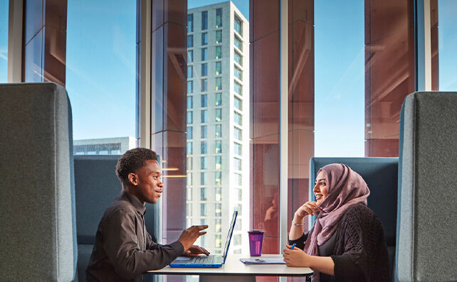 Picture of two students studying on campus