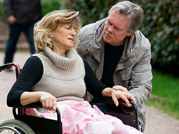 A care worker visits a client at home Care worker attends to woman in wheelchair