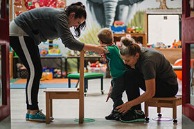 NICE - adults helping a child to walk 