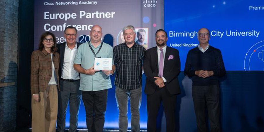 Six people stood in a row collecting the award.