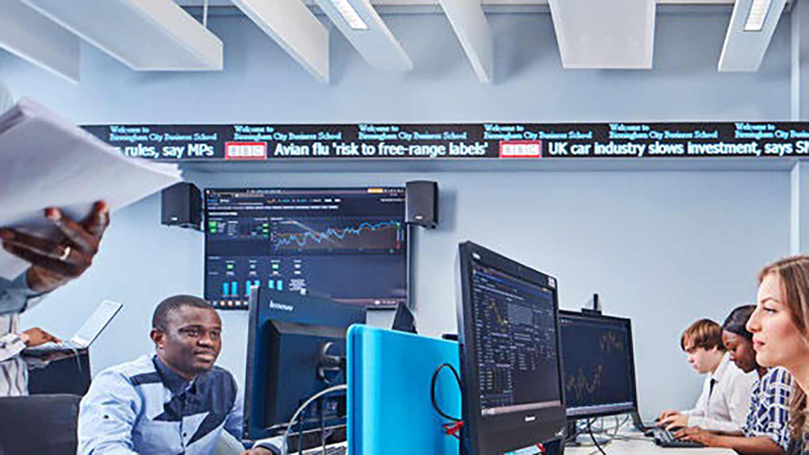 Students with computers in the City Trading Room