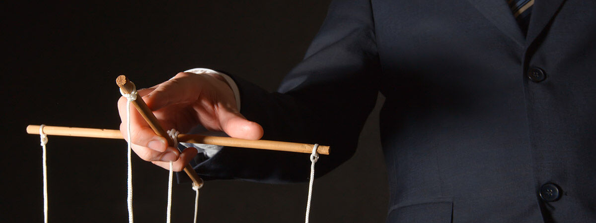 Coercive Control 1200x450 - Man holding puppet strings