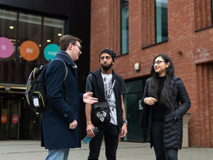 Students chat as they leave campus
