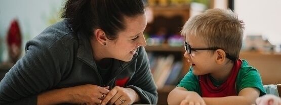 Student working with young child