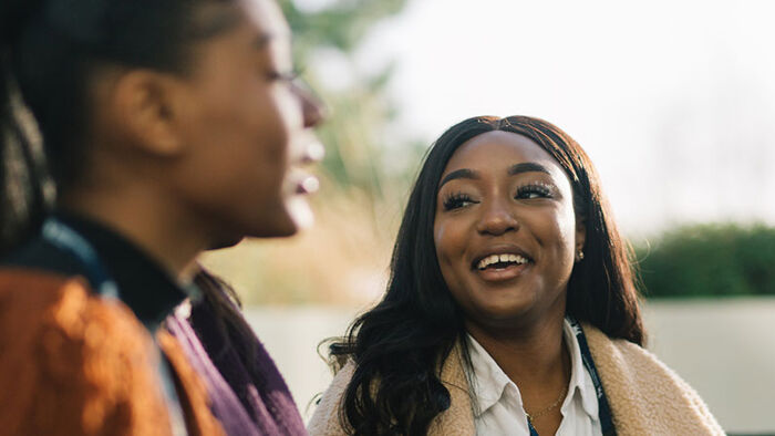 two students talking outside