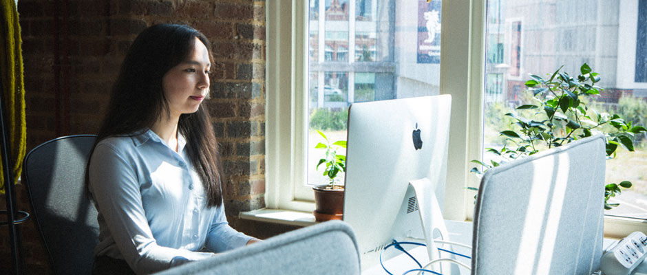 A student completing a virtual interview dressed in smart clothes