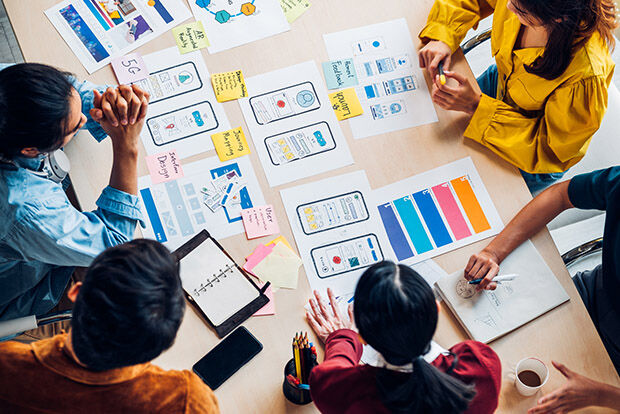 Creatives discuss their work around a table