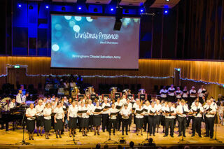 Salvation Army band and choir on Bradshaw Hall stage