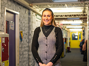 Education Studies alumna, Danielle Williams, stands posing for her I AM BCU photo in Royal Birmingham Conservatoire.