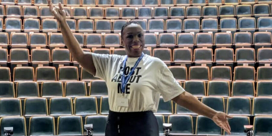 Deb Tracey stood in on a stage.