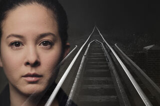 Woman's face superimposed over railway lines, single point perspective