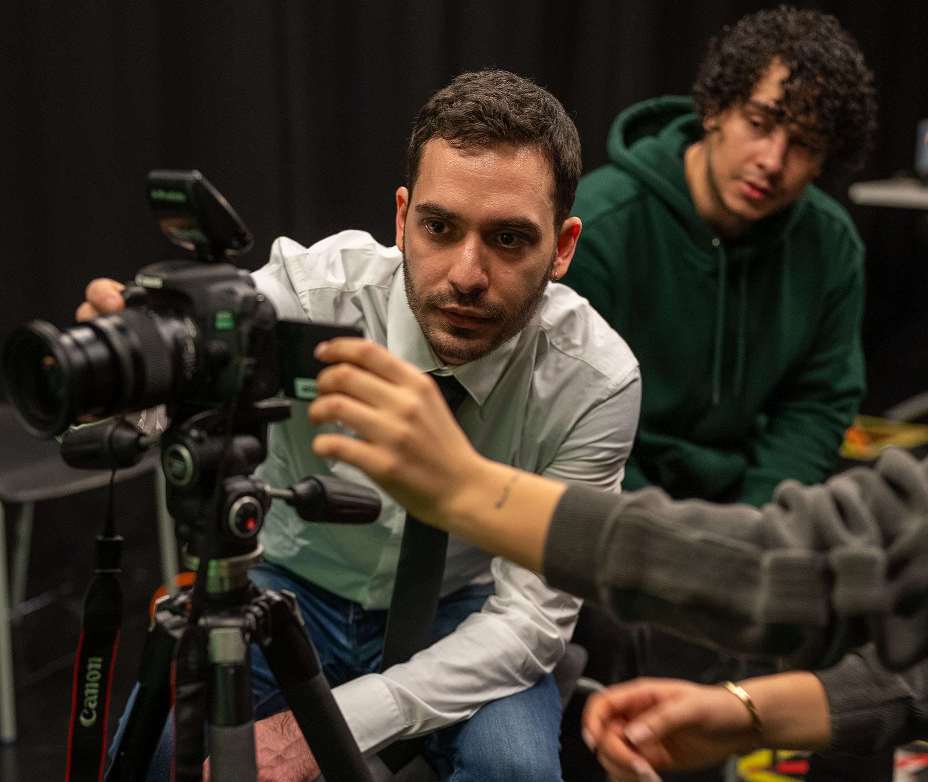 Lecturer using media equipment whilst students watch