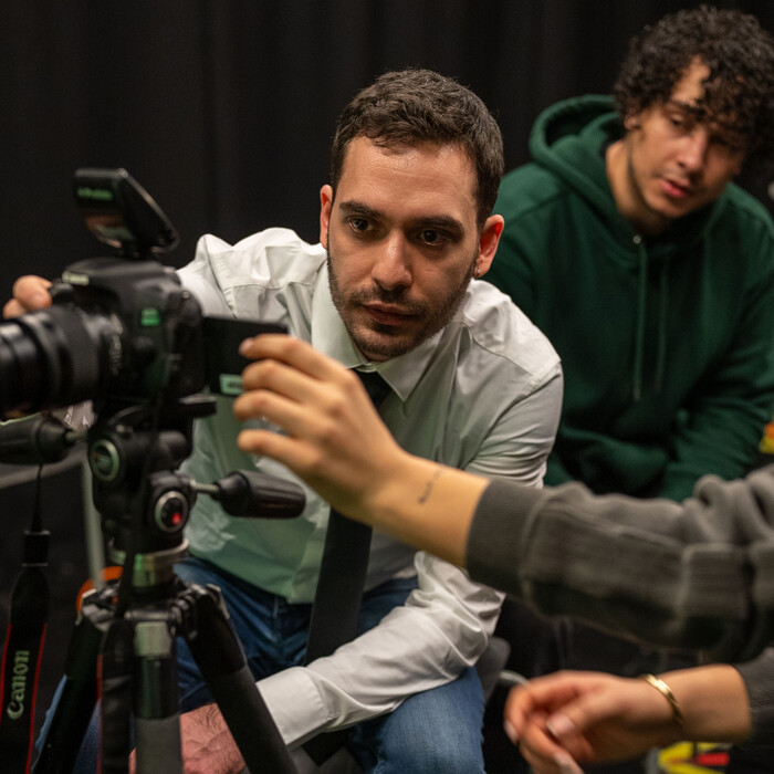 Lecturer using media equipment whilst students watch