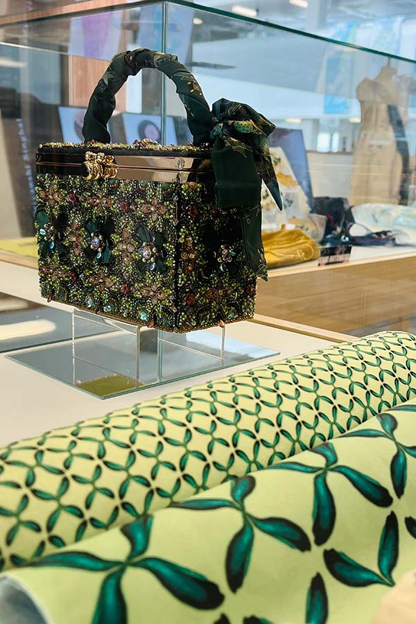 Embroidered box on display with rolls of fabric from MA Textile and Surface Design
