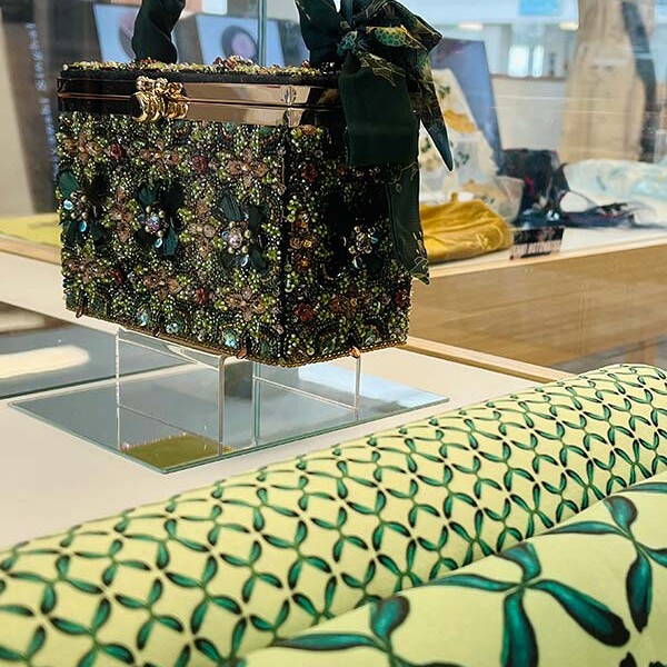Embroidered box on display with rolls of fabric from MA Textile and Surface Design