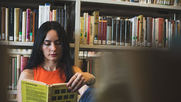 A student reads a book in the library