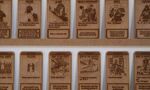 A collection of laser-engraved wooden cards, each featuring an illustration of a fantasy or sci-fi character and a short block of text.